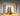 Various Greentree brand candles in holders, lit
