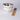Two ceramic bowls with floral design and a set of wooden chopsticks on a light gray background