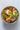 bowl of noodles with egg and green onions on a white background
