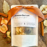 Packaged product labeled 'Autumn Harvest' with decorative elements on a wooden surface