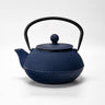 Blue textured teapot with black handle on a white background