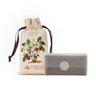 Sachet with cherry blossoms on the front next to a bar of soap