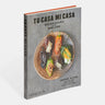 Cook Book titled, “Tu Casa Mi Casa; Mexican Recipes for the Home Cook” by Enrique Olvera. Photograph of an earthen bowl with stuffed peppers. 