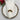 Decorative Christmas wreath on a folded white napkin with a silver charger plate and floral arrangement.