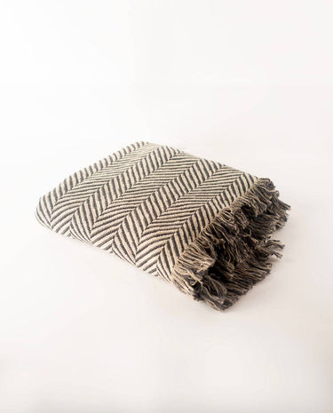 Henry blanket folded. Herringbone pattern with fringe.