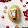 Grape hand cream on a marble background with grapes around the bottle