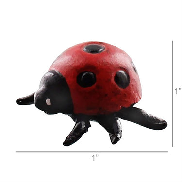 Small red and black ladybug figurine with measurement markings.