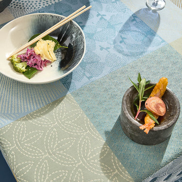 Two small dishes with food on a patterned tablecloth