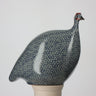 Ceramic guinea fowl with blue and white pattern on a gray background