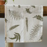 White table runner with fronds draped over table