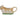 Cow shaped creamer laying on a bed of green grass