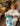 Woman holding a teal pot with a blue towel in a store setting