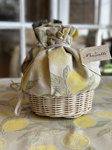 Wicker basket with cloth top in cream and yellow lemon pattern
