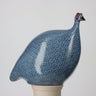 Ceramic guinea fowl sculpture with blue pattern on a white background