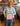Person holding a floral fabric panel in a fabric store