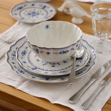 Douro Collection Flatware in Polished shown with Vila Blue and White Dinnerware Collection.