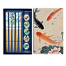 Set of chopsticks with decorative ends in a box, featuring koi fish design on the packaging.