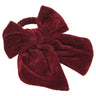 A large bow napkin ring made of plush burgundy velvet, shown against a plain white background.
