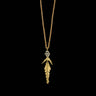 Gold necklace with a leaf-shaped pendant on a black background