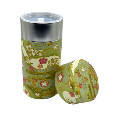 Floral-patterned tumbler with a matching round container on a white background